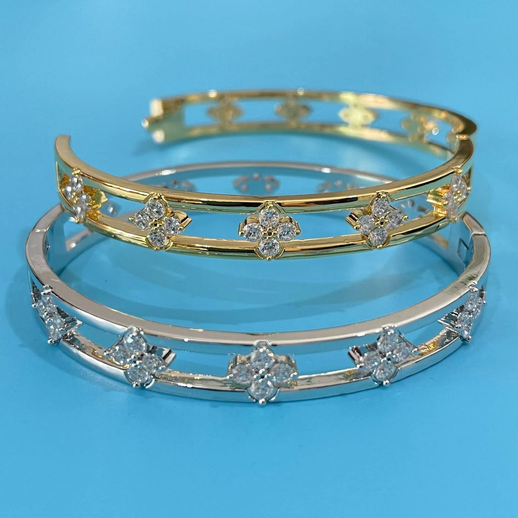Gold or silver hollow women's bracelet with a four-leaf clover charm containing a white zircon stone.