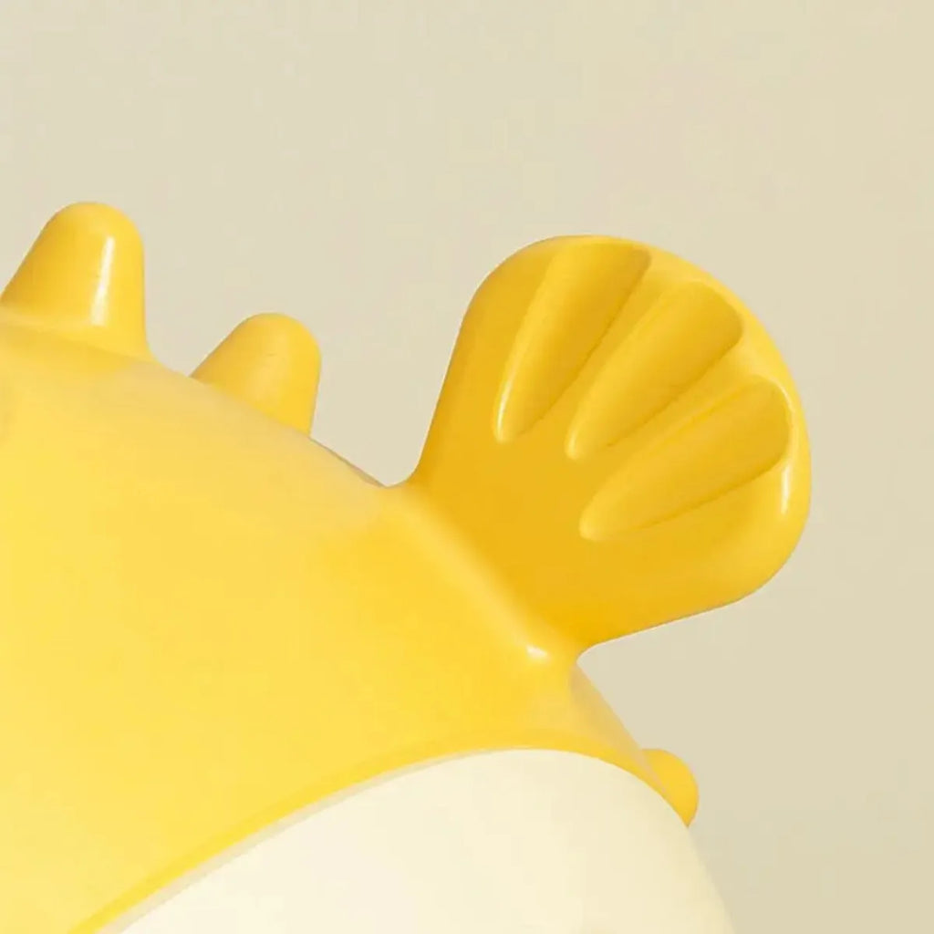 Yellow fish-shaped vinyl dog chew toy with textured surface for teeth cleaning.