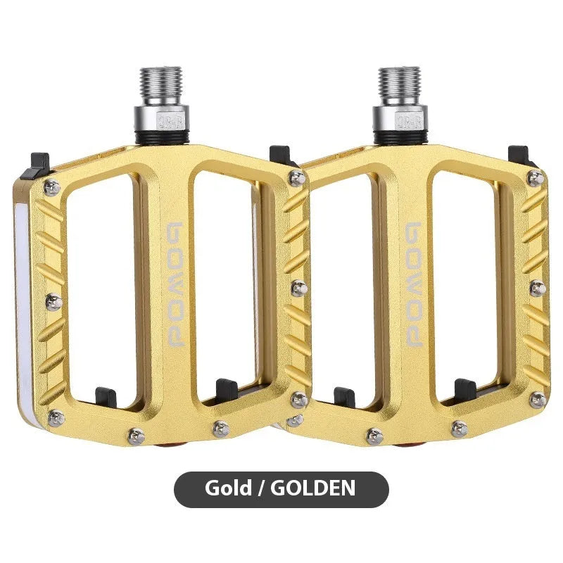 Bicycle pedals with LED lights in purple, black, titanium, red, and gold colour options