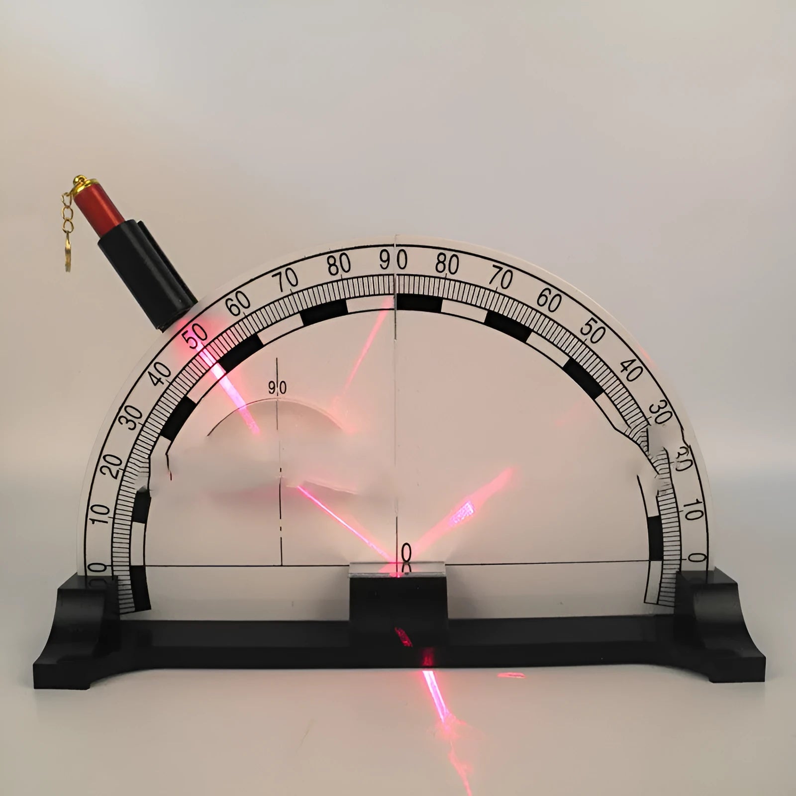 Iron plate optical physics teaching instrument with laser pen on a classroom table