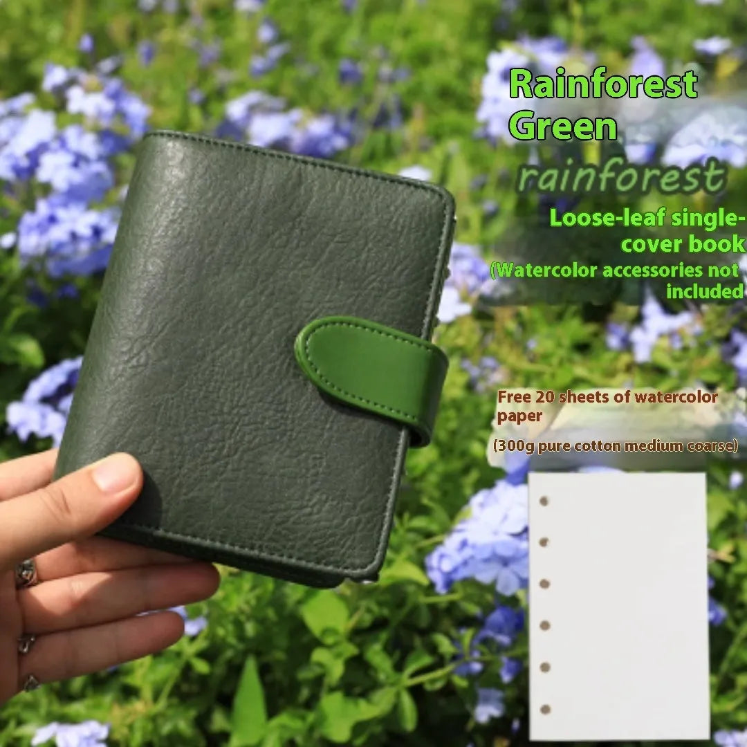 A7 format loose-leaf watercolour sketchbook in avocado green, open to show blank watercolour paper.
