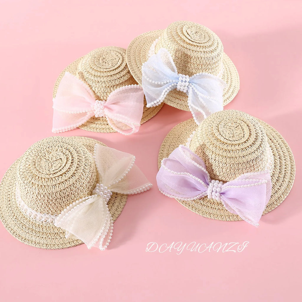 Cat wearing a woven straw hat with a pearl bow decoration in a princess style.