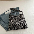 Leopard print shoulder messenger bag with square vertical shape and single strap, available in black, brown, and pink