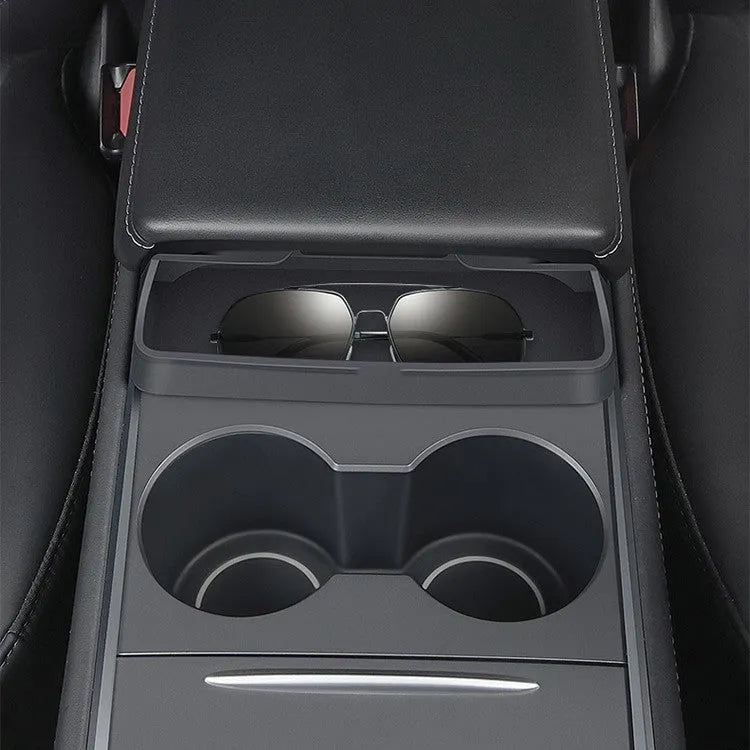 Black silicone glasses case mounted on a Tesla Model 3 or Y central armrest.