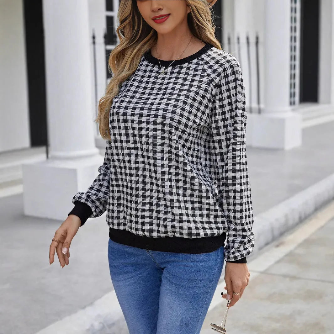 Black long sleeve pullover sweater with plaid pattern and printing detail showing front view