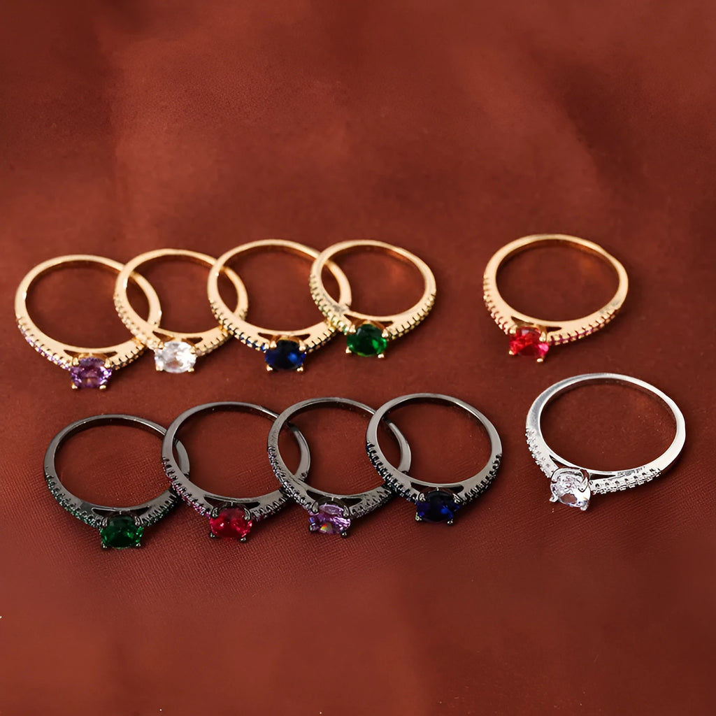 Hexagonal geometric copper ring with zircon electroplating in a gold rose red finish on a hand.