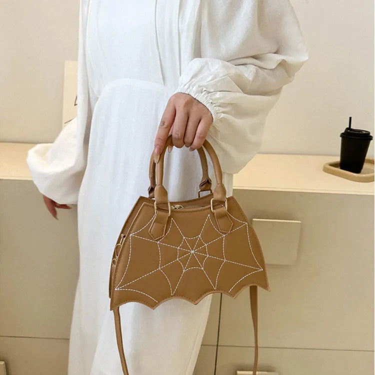 Women's small square PU saddle bag with spider web pattern, crossbody strap, and top handle, available in six colours including black and red