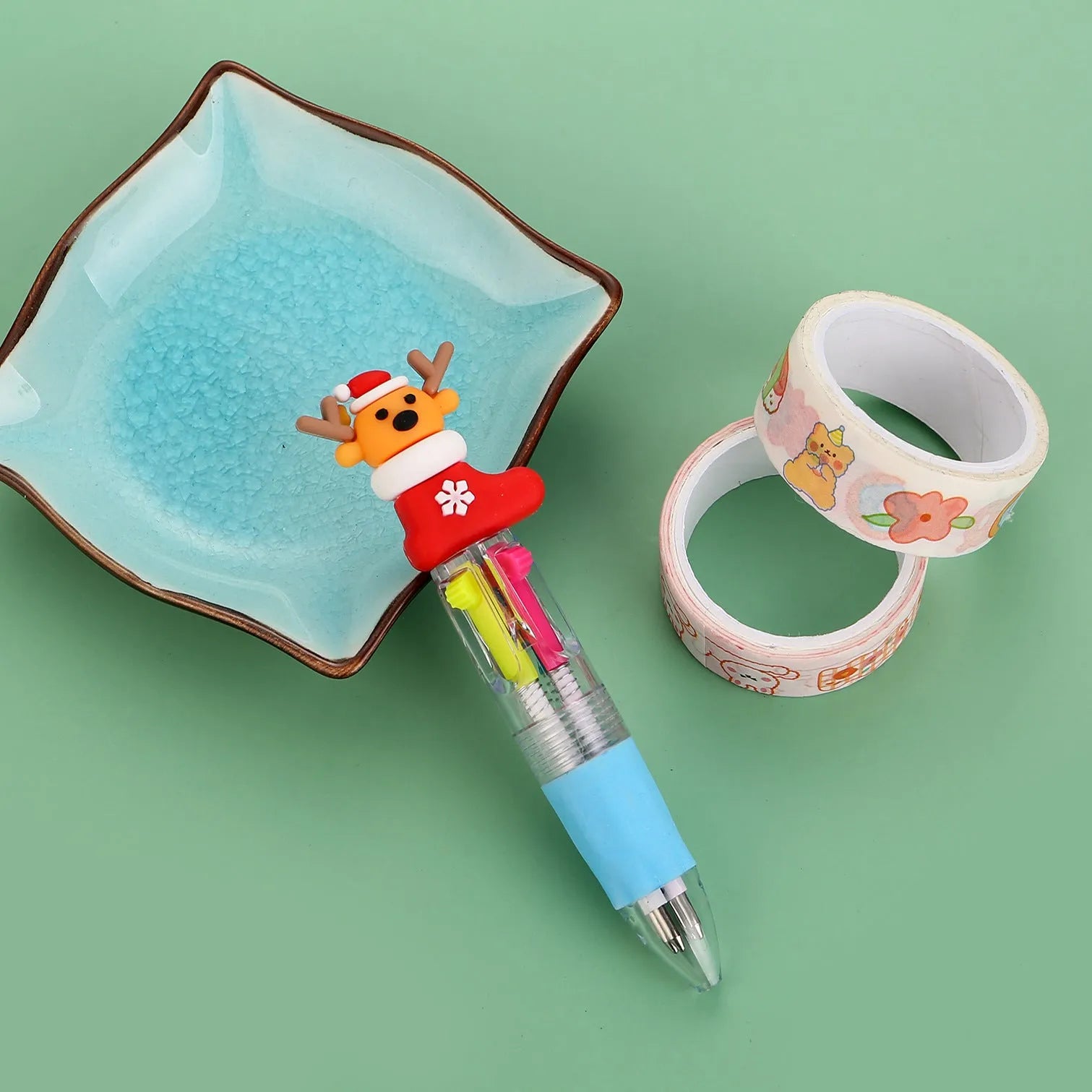 Compact 11cm Christmas-themed press-action ballpoint pen with festive designs.