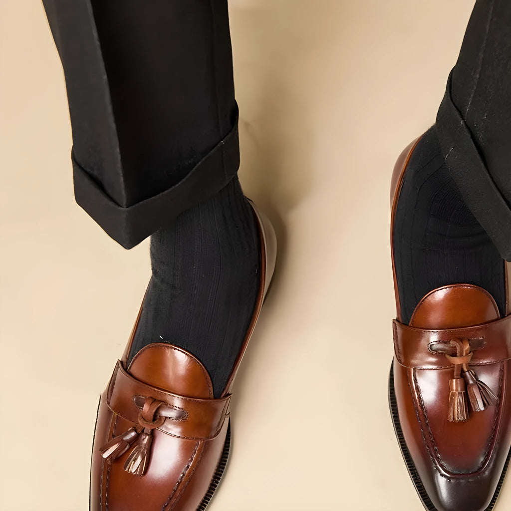 Men's black and brown polished leather tassel loafers with pigskin lining and rubber soles