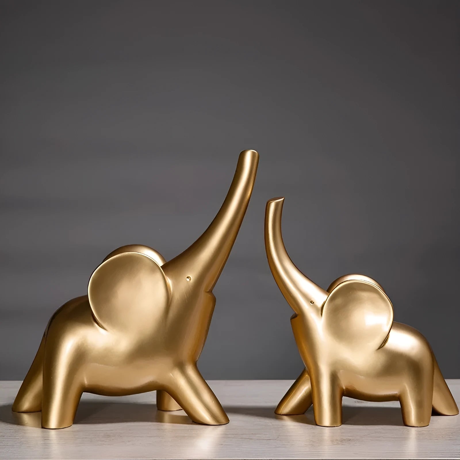 Minimalist solid resin elephant ornament in rose gold on a shelf.