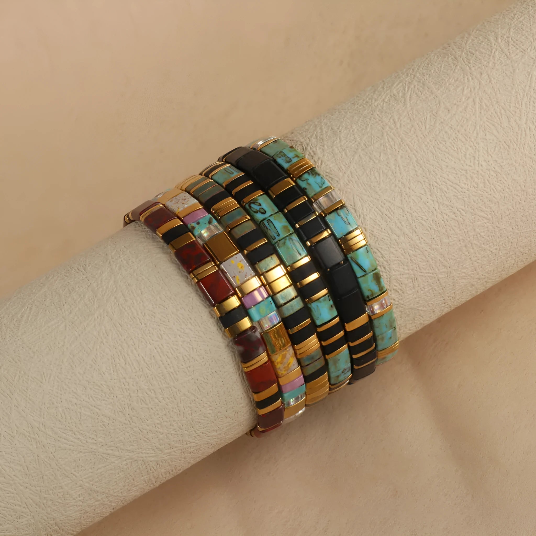 Geometric pull bead bracelet in milky white glass beads on a wrist.