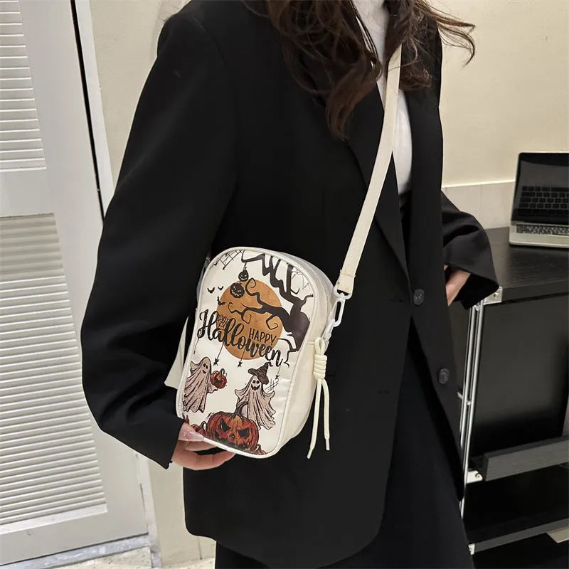Black Halloween graffiti crossbody bag with pumpkin, ghost, and bat print