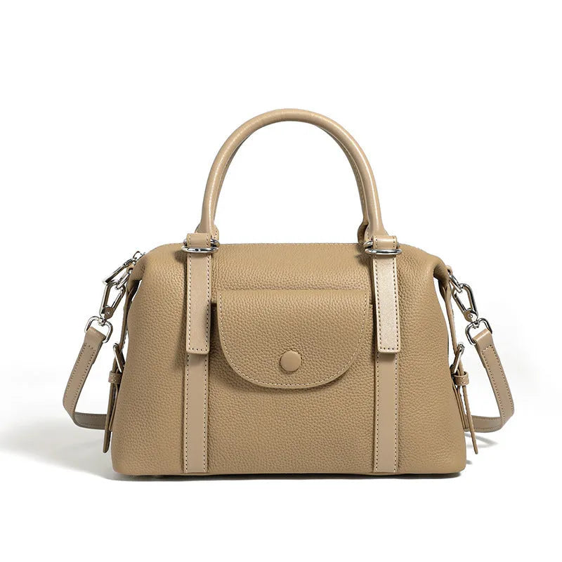 Genuine leather ladies handbag in street trend style with contrast stitching and lock detail.
