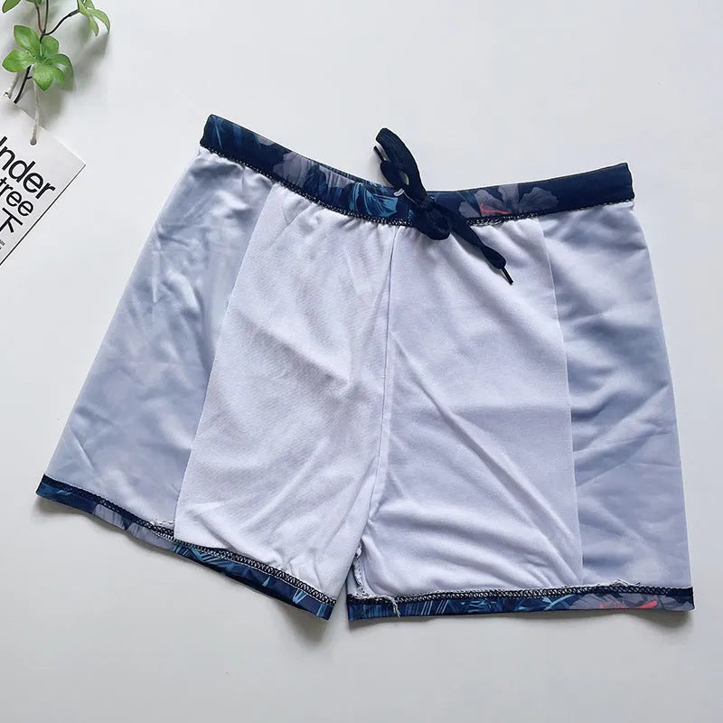 Men's loose-fit polyester swim trunks in dark blue with large flower print, three sizes available