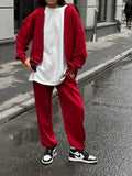 Women's red street style two-piece set with long-sleeved coat and matching trousers, loose fit.