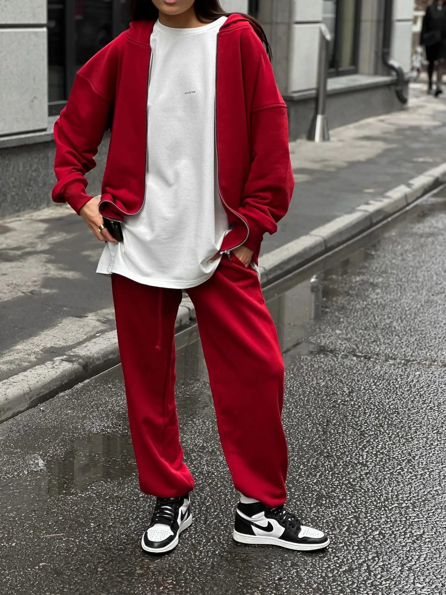 Women's red street style two-piece set with long-sleeved coat and matching trousers, loose fit.