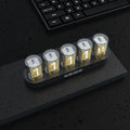 RGB LED digital clock showing colour-changing display on desk with black plastic casing