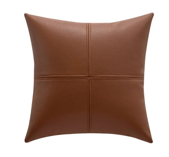 Soft cowhide leather pillow cover in a solid colour on a sofa.