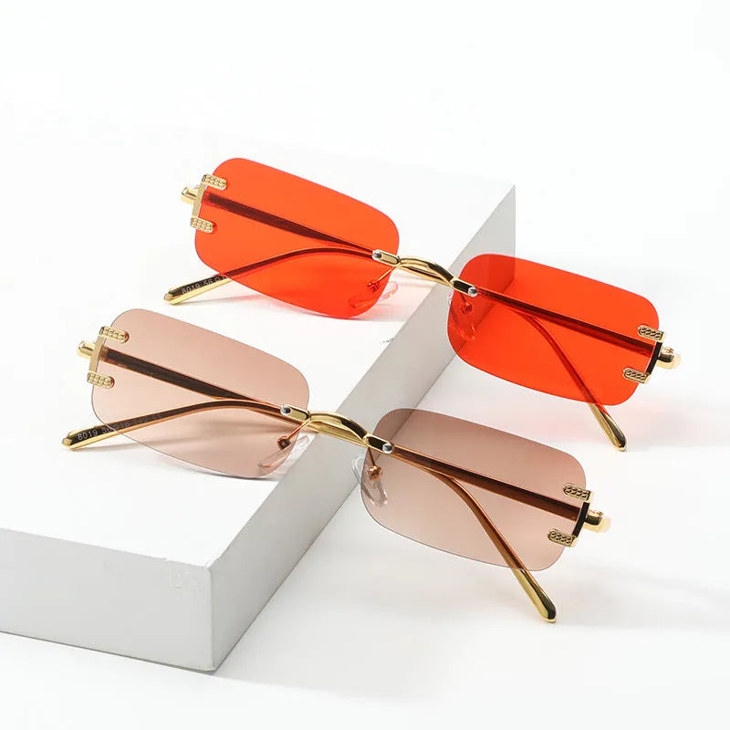 Retro square frameless sunglasses with gold metal frame and black/grey AC lenses