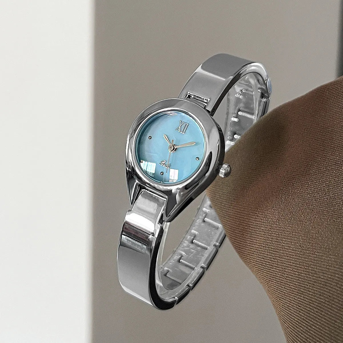 Women's quartz watch with 30mm white shell dial, silver hands, and white strap on display