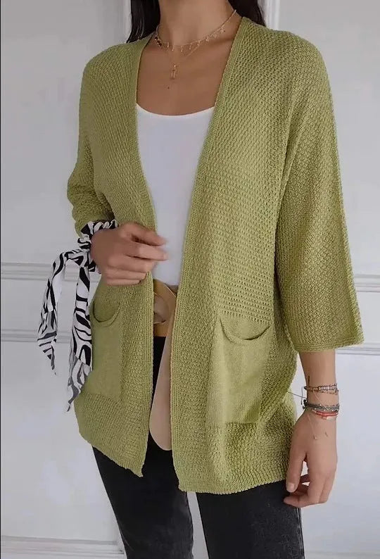Women's army green waffle weave cardigan coat with nine-quarter length sleeves and pockets.