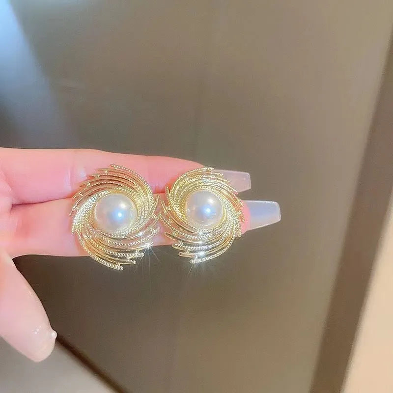 Flower shaped vintage earrings with exaggerated pearl centres and irregular design elements