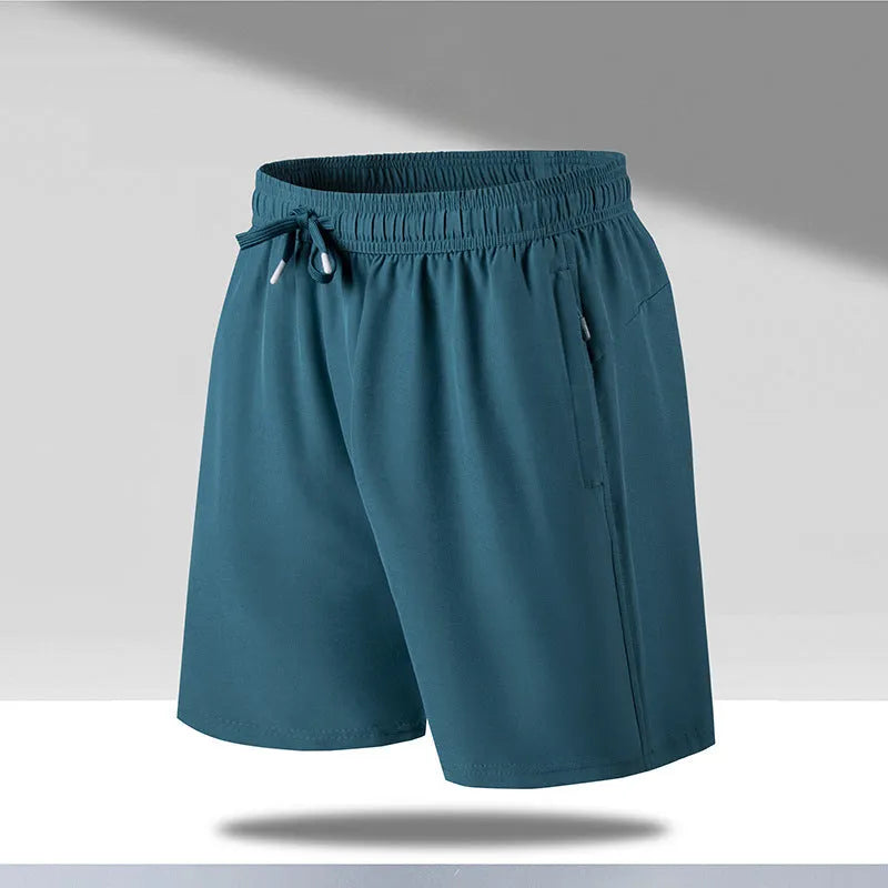 Man wearing loose-fit black quick-drying polyester beach shorts with a micro-elastic waistband.