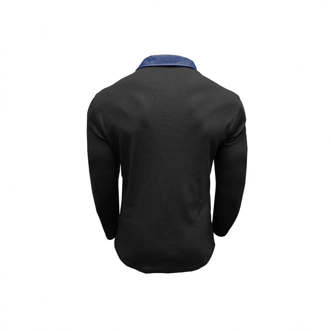 Man wearing a long-sleeved waffle knit polo shirt in a solid colour with an asymmetric design detail.