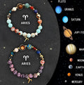 Set of two natural stone beaded bracelets showing zodiac sign designs on elasticated cords