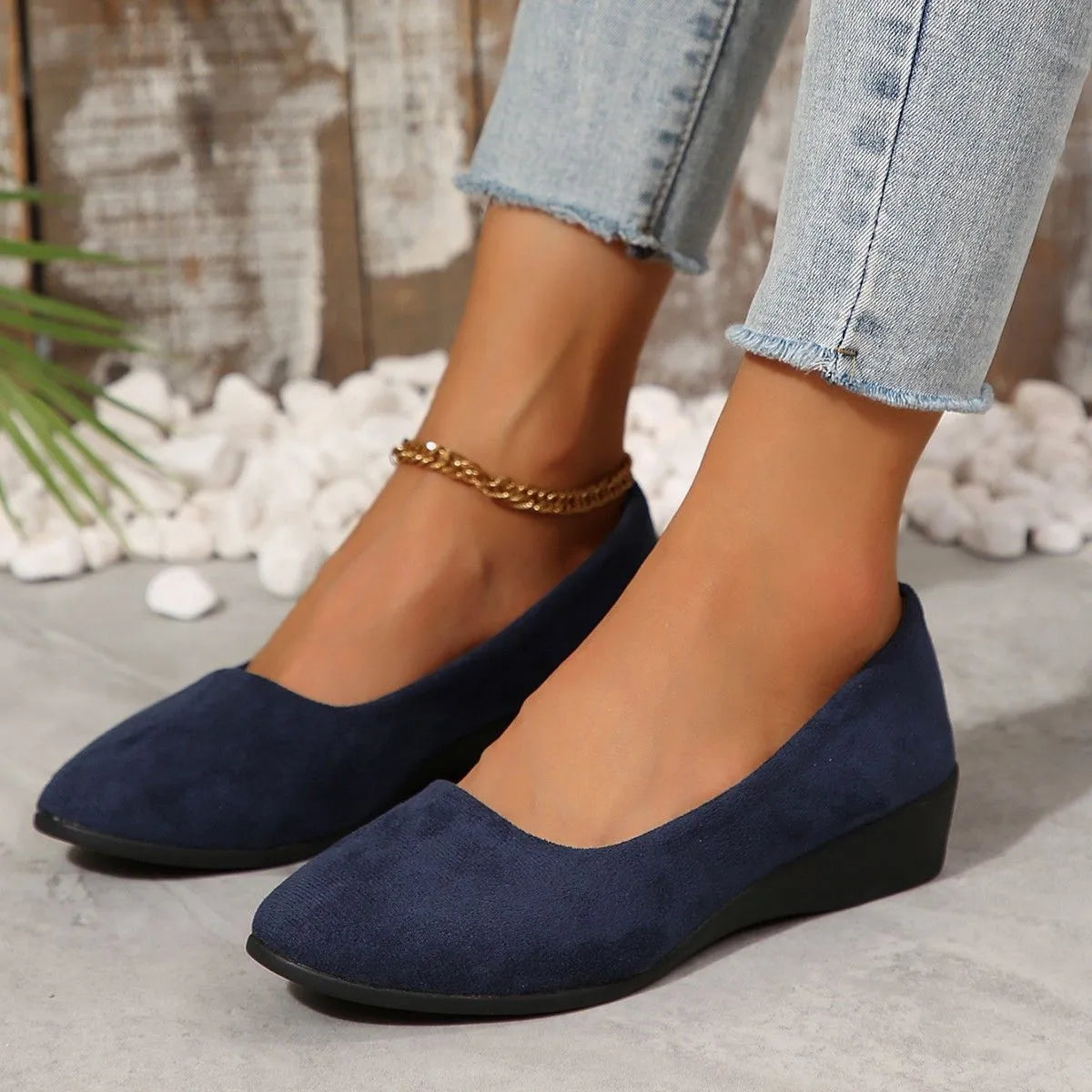 Women's suede wedge pump shoes in light brown with a low rubber sole and rounded toe.