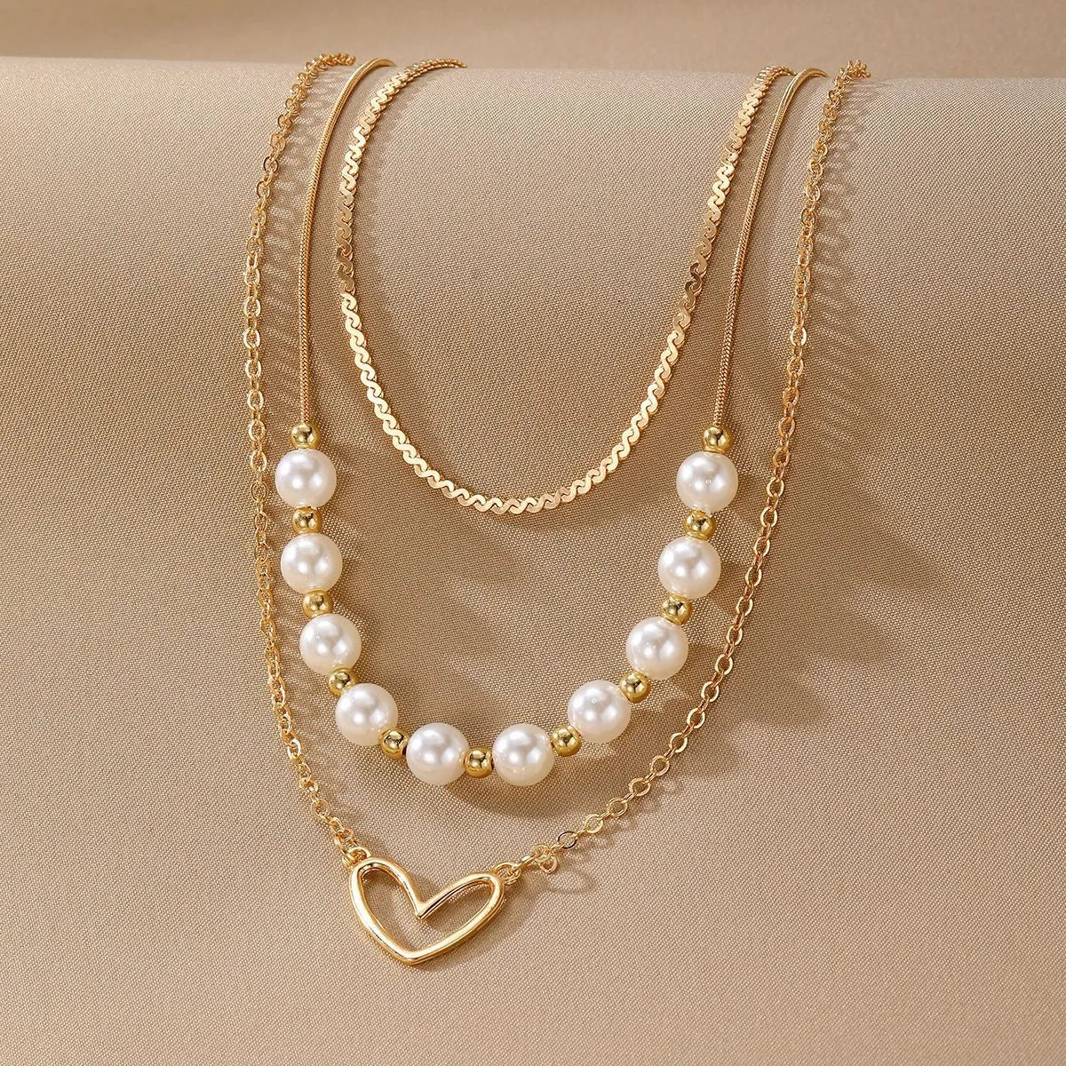 Vintage gold heart pendant necklace with pearl chain detailing showing adjustable length feature