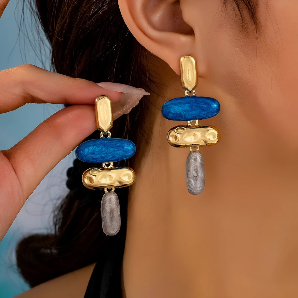 A pair of simple geometric stud earrings with a multicolour electroplated finish.
