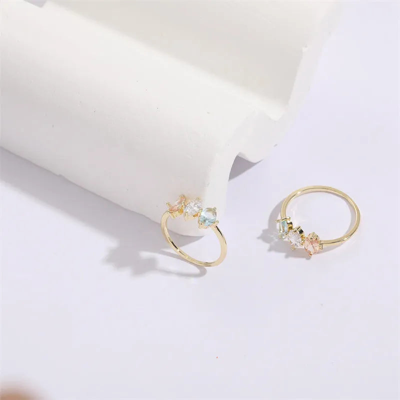 Geometric birthstone ring with horse eye shaped tricolor zircon stones in gold colour