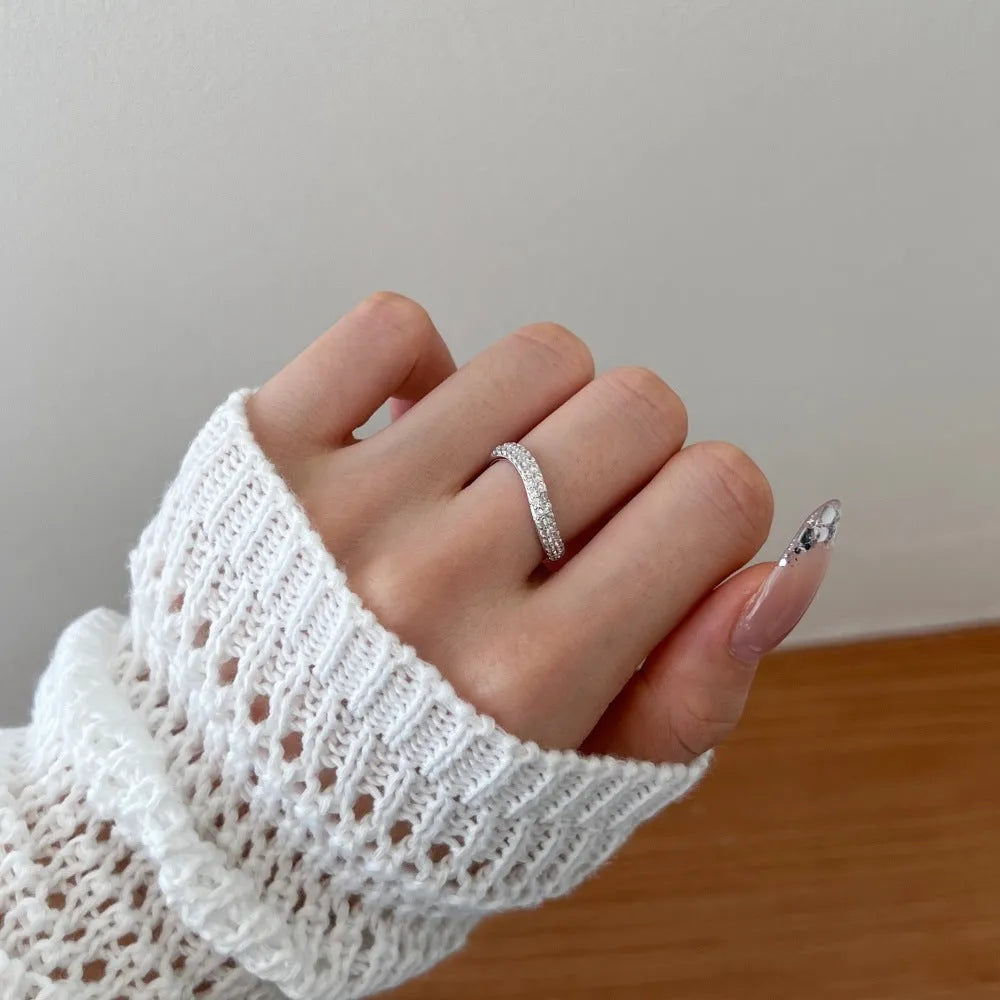 Female S925 sterling silver snake-shaped ring with zircon inlay in platinum finish on white background
