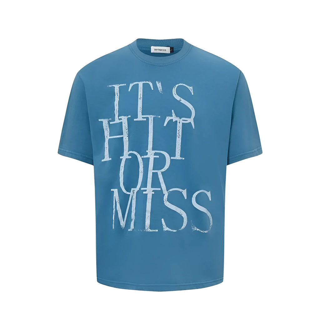 Man wearing a blue loose-fit American retro t-shirt with a white letter print design.