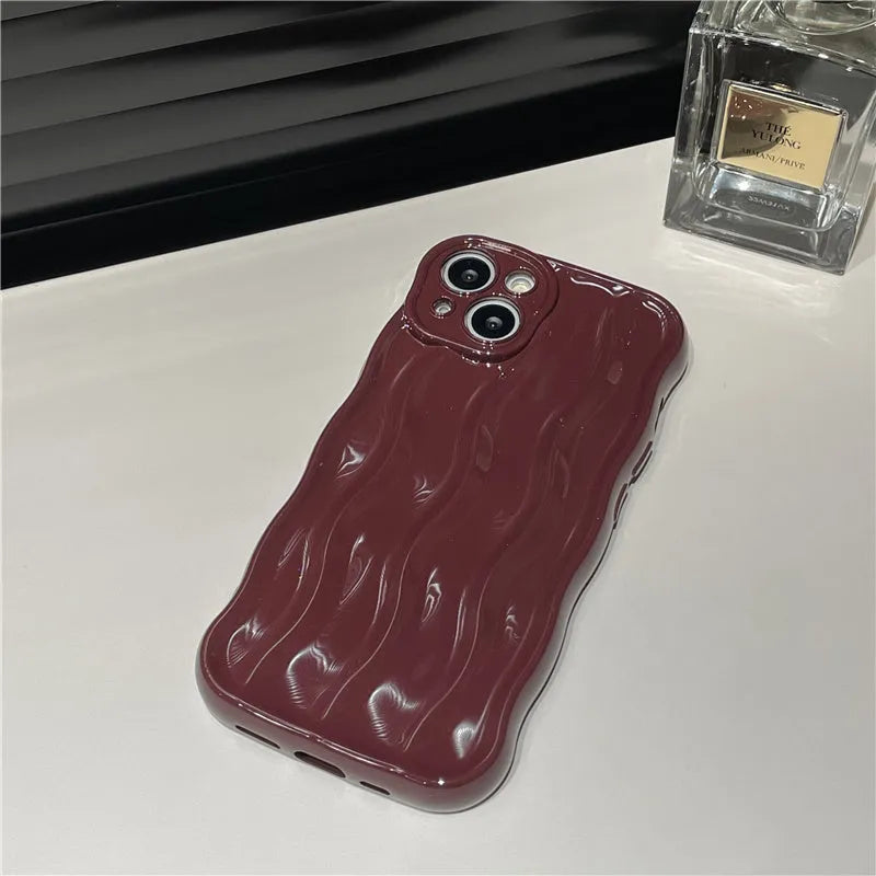 Silicone iPhone 17 phone case with water ripple texture in burgundy colour.