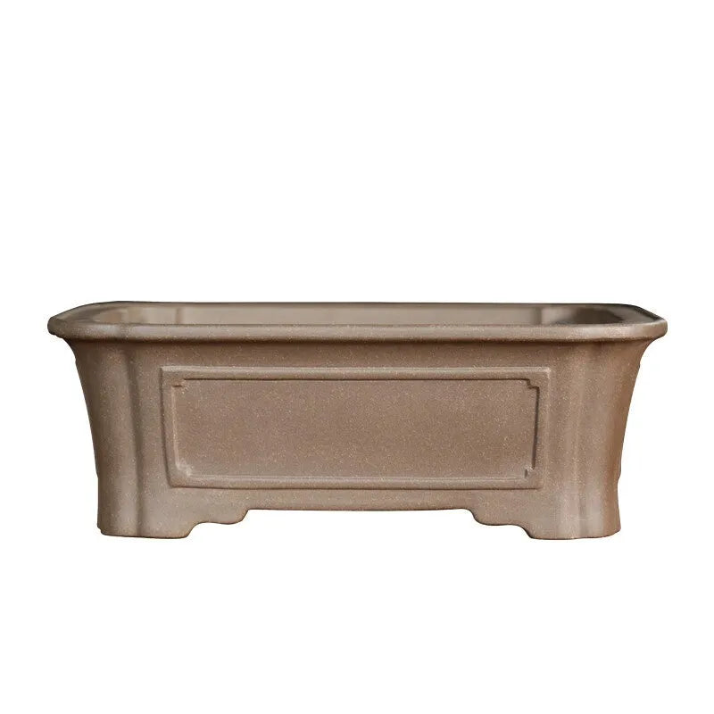 Rectangular antique purple sand bonsai planter with corner-cut design on floor.