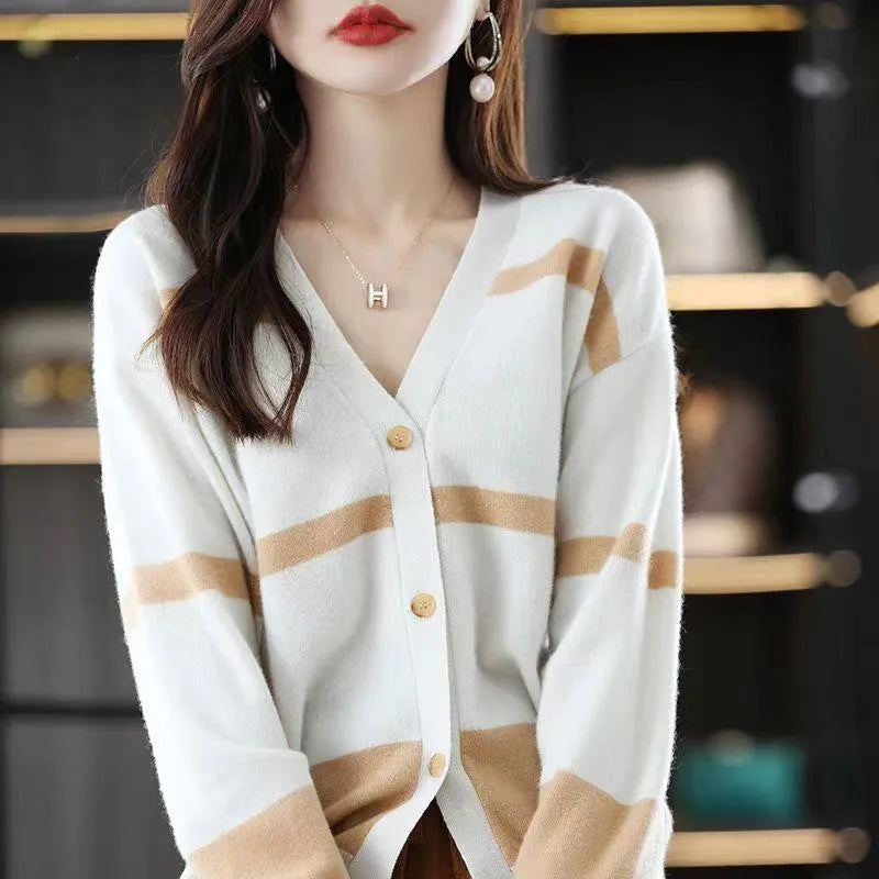 Women's black and white striped V-neck knitted cardigan with 3D pattern on a hanger.