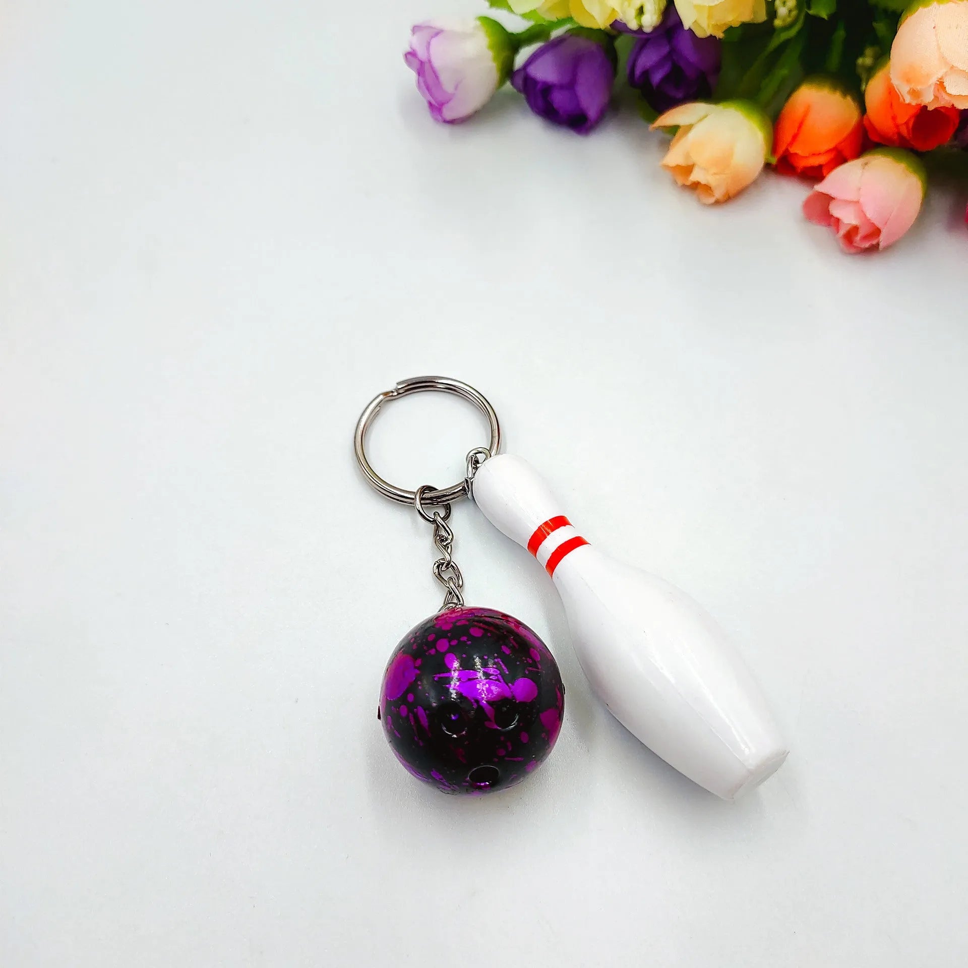 Mini bowling pin keychain pendant in four colour options with key ring attachment
