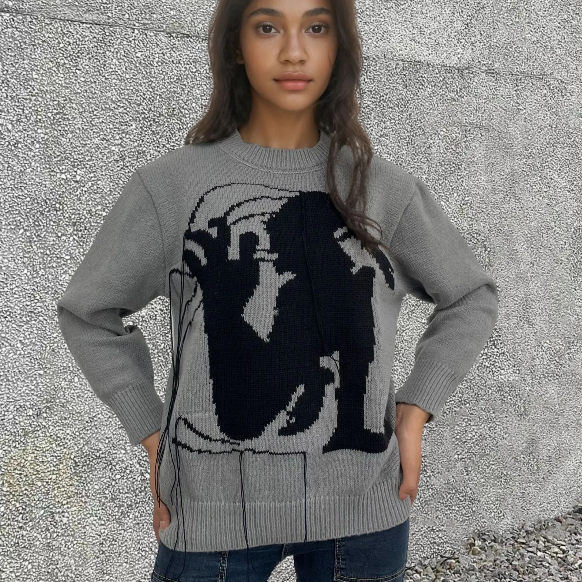 Grey women's loose alpaca wool sweater with tassel detail and abstract pattern, round neck.