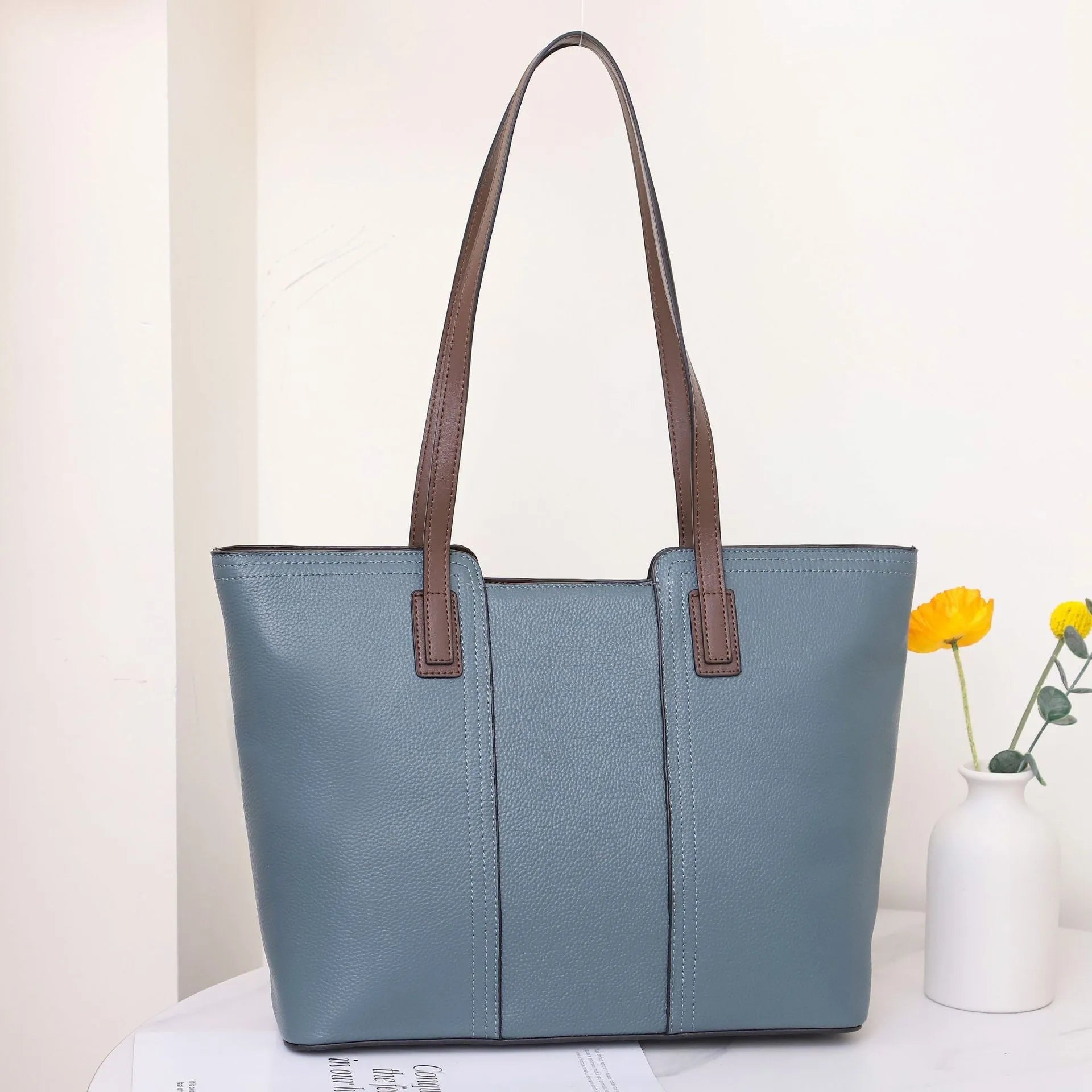 Women's genuine leather shoulder bag in khaki colour showing box-type design and organised interior compartments