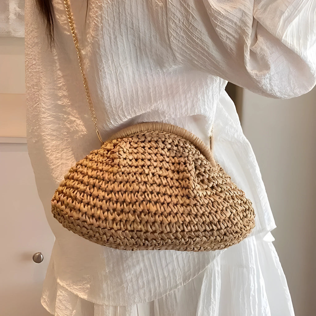Women's khaki paper straw shoulder bag with chain strap and shell shape showing internal zippered compartment