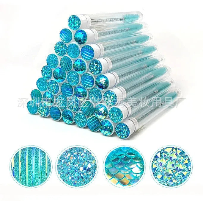 Disposable eyelash brushes in blue, green, pink and purple colours with transparent protective storage tubes