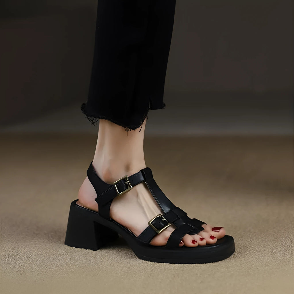 Black retro women's platform sandals with a T-buckle fastening and chunky heel.
