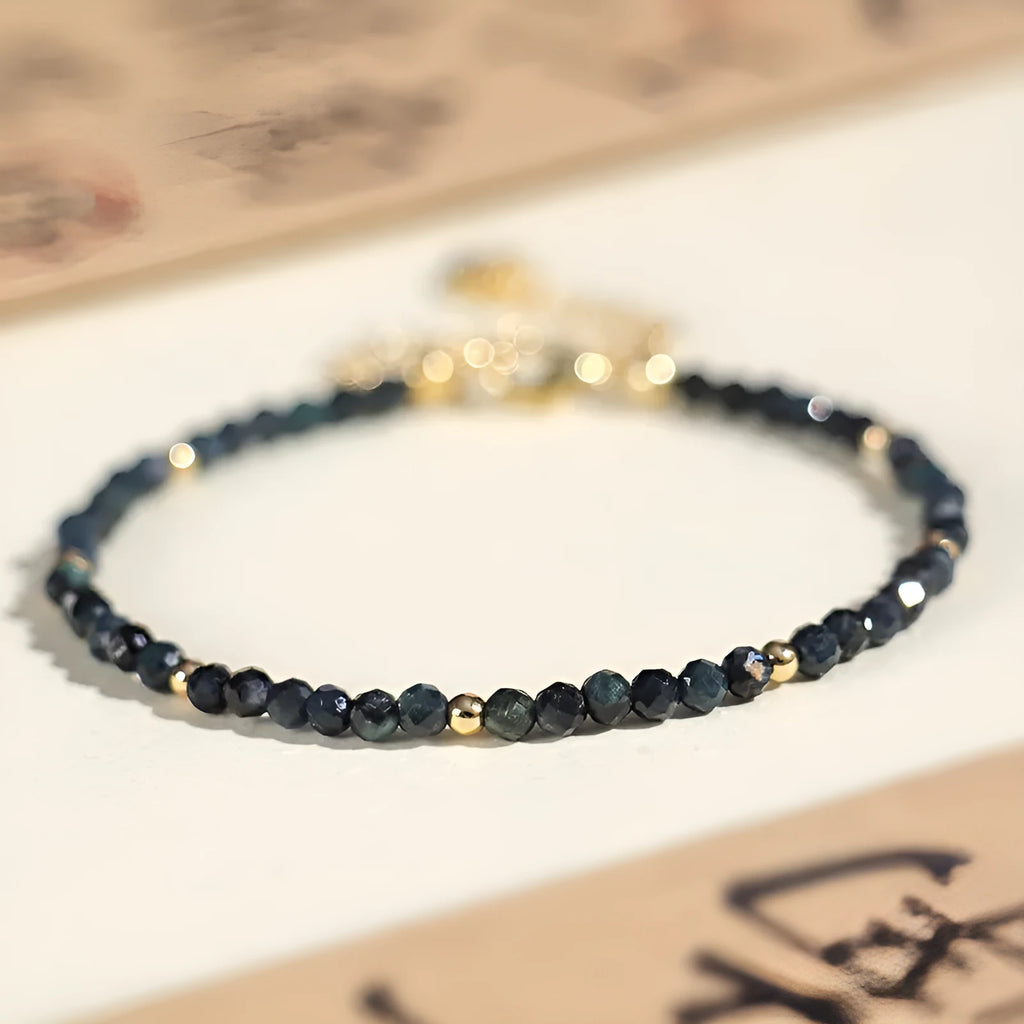 Close-up of a women's blue tourmaline beaded bracelet with 3mm gemstone beads and spacer details.