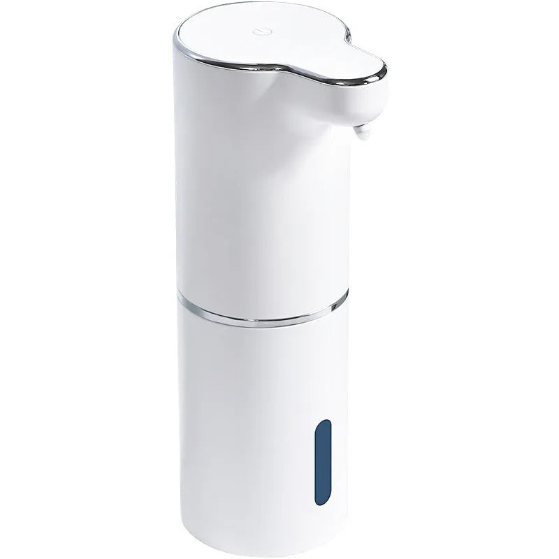 White ABS automatic sensor soap dispenser on countertop with USB cable, dispensing foam hand sanitiser.