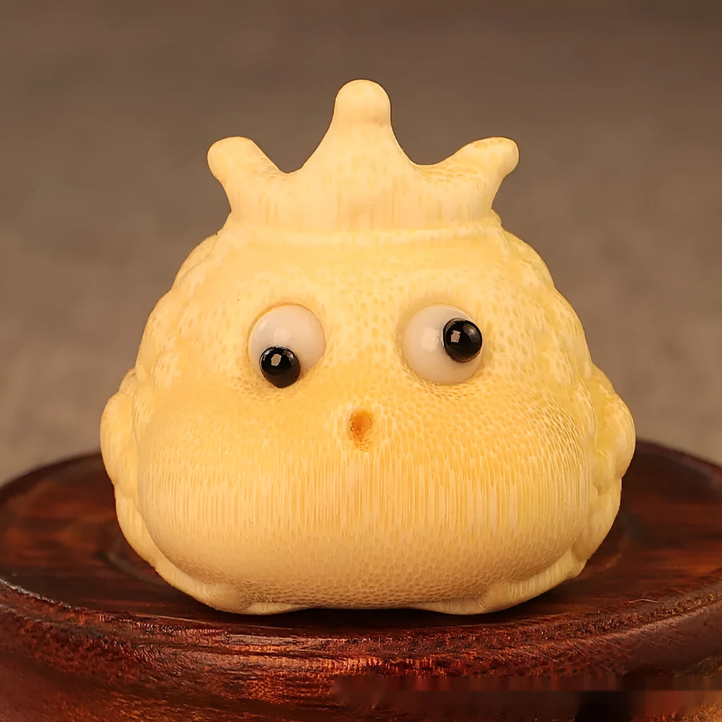 Solid bamboo carving of a cute Crown Princess Toad ornament, showing live eye detail.