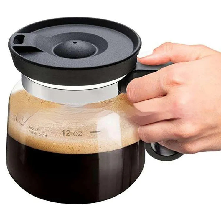 Transparent borosilicate glass stovetop coffee maker with a black silicone cover