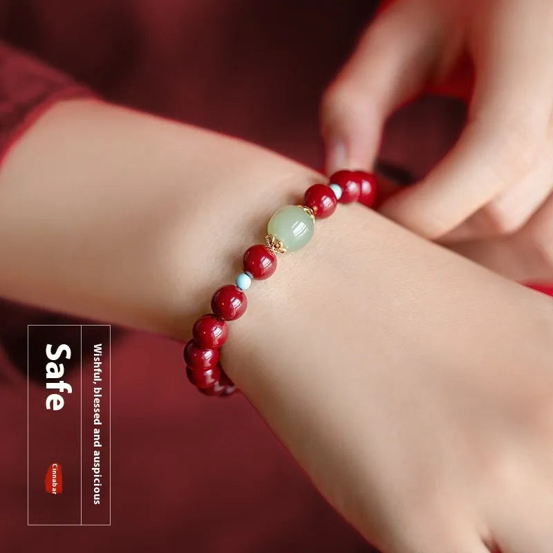 Purple gold sand cinnabar and Hetian jade geometric ellipse bead unisex bracelet on a wrist.