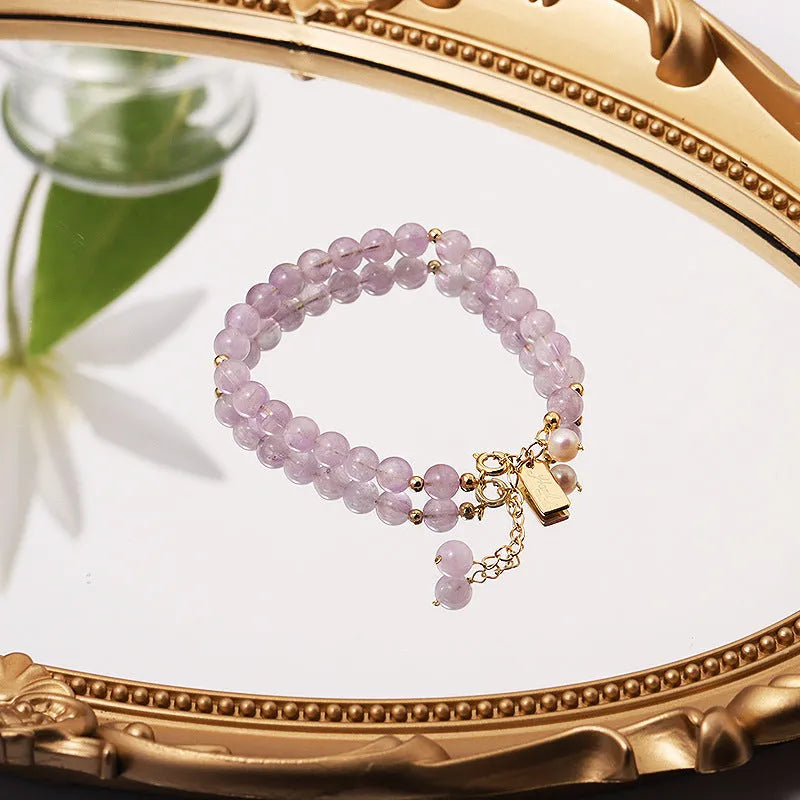 Women's natural lavender amethyst crystal bracelet showing dark and light colour options